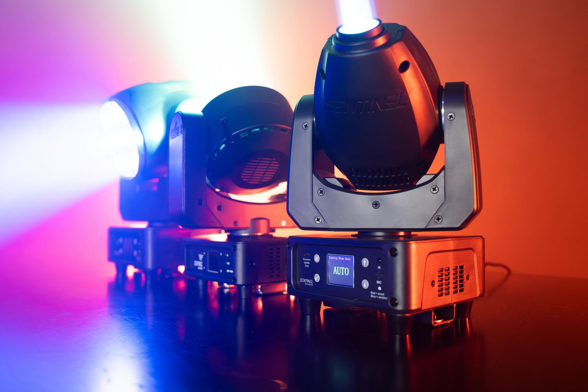 Chauvet DJ Sentinel Series Moving Head Wash and Spot Lights Family Line-up Shot on the ground with pink and purple background