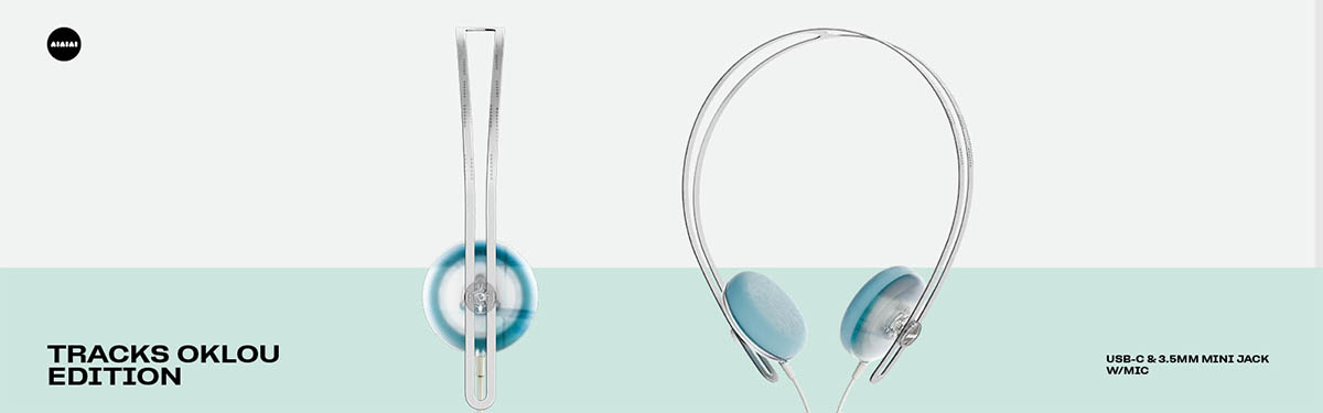 Front and side views of the AIAIAI Tracks Oklou Edition headphones, featuring a transparent headband and icy blue on-ear cushions.