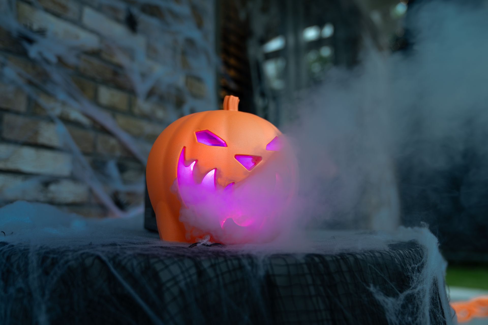 Halloween pumpkin Smoke machine producing a thick stream of white fog