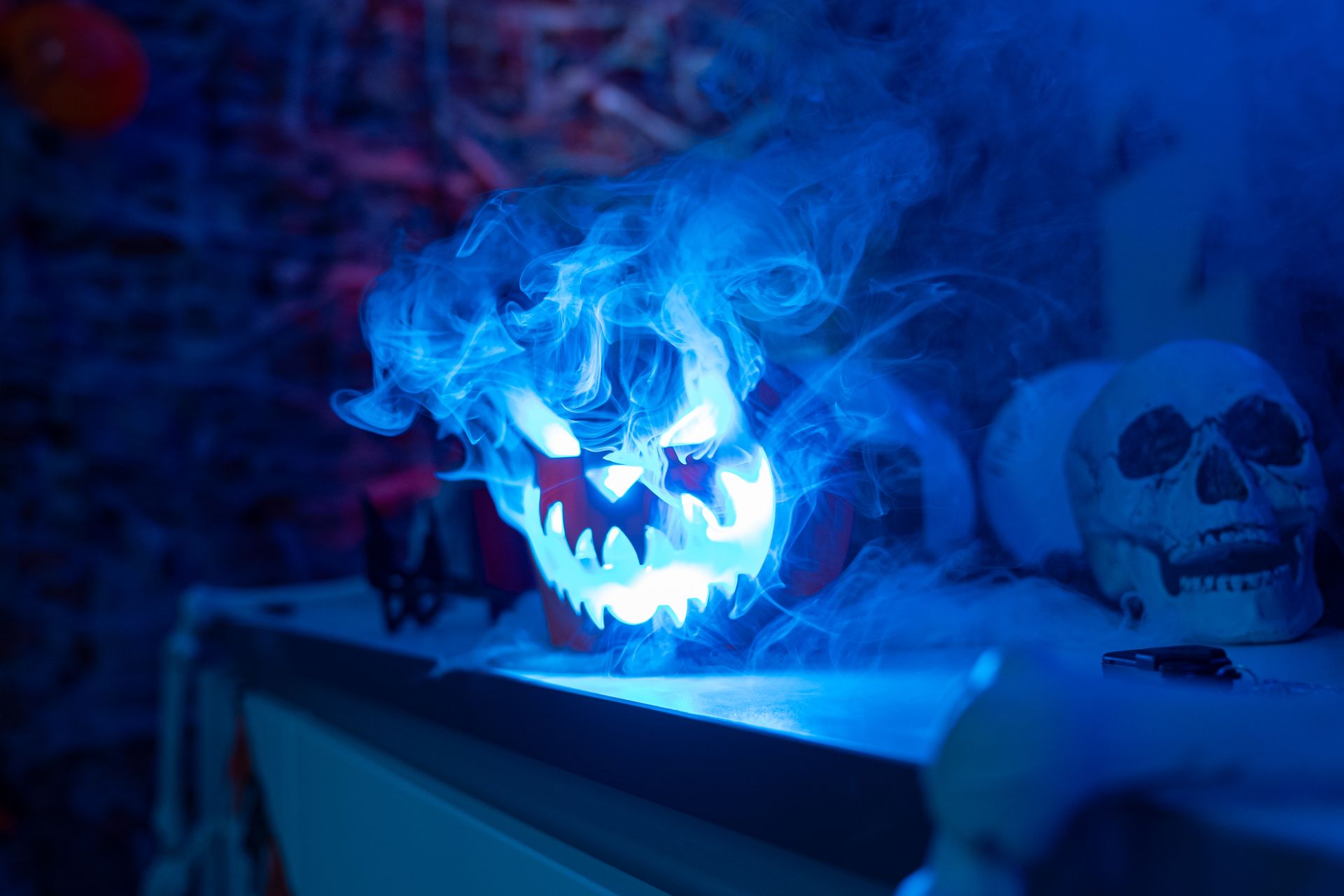 In-situ shot of BeamZ lighted Halloween pumpkin cover fitted around a compatible smoke machine